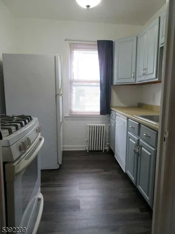 a kitchen with stainless steel appliances a stove a sink and a window