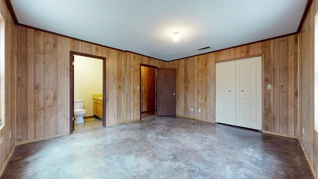 an empty room with closet area