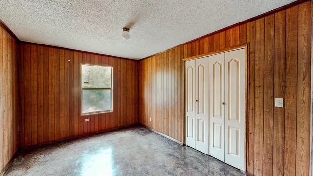a view of an empty room with wooden door