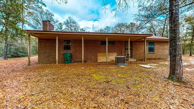a backyard of a house with barbeque oven fire pit table and chairs
