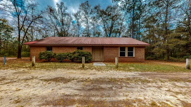 a view of a small house with a yard