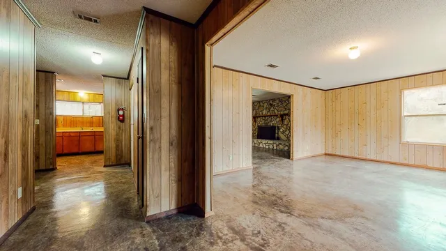 a view of a hallway with wooden shelves