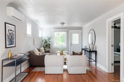 a living room with furniture or wooden floor and a large window