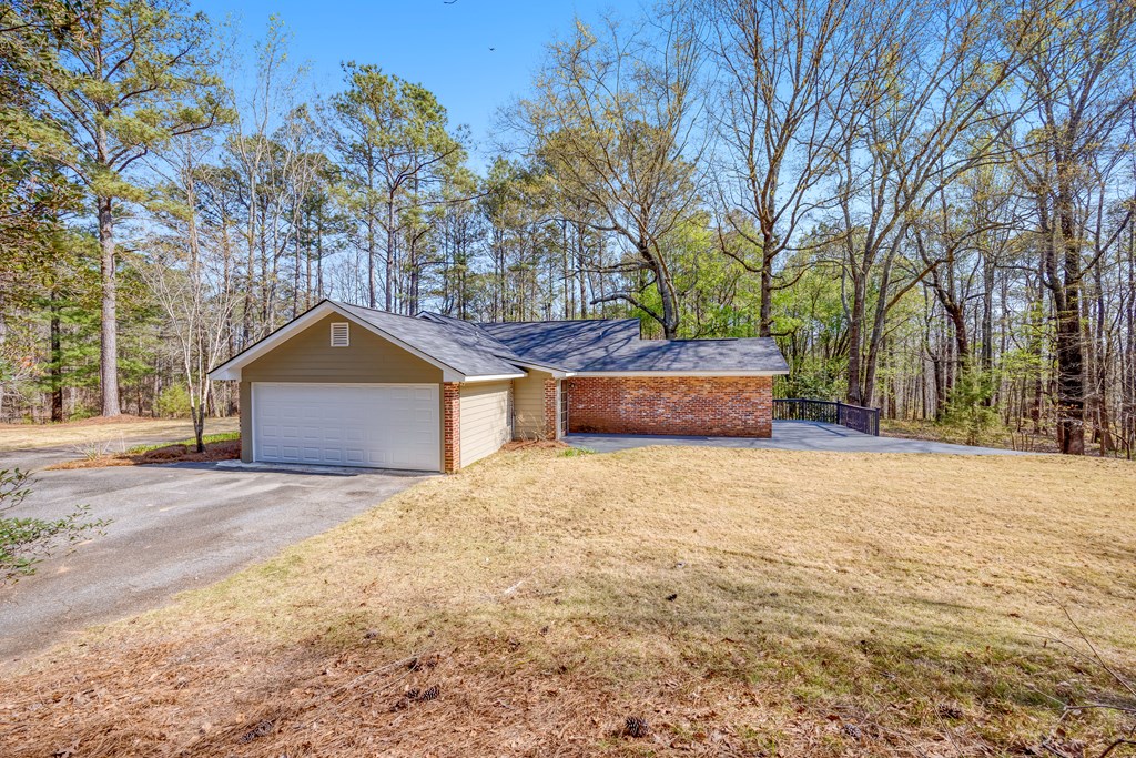 3330 Fortson Road Fortson, GA 31808 - Photo 11 of 46 a front view of a house with a yard and a garage