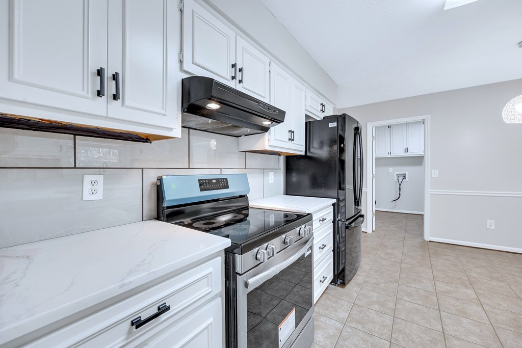 3330 Fortson Road Fortson, GA 31808 - Photo 25 of 46 a kitchen with stainless steel appliances a stove a refrigerator and cabinets