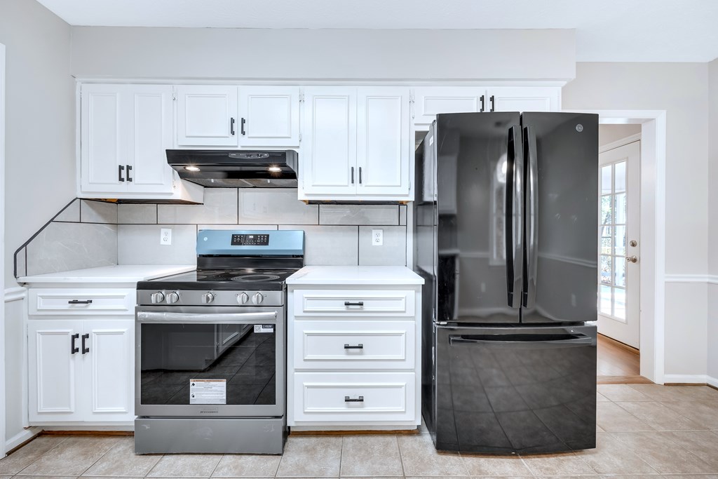 3330 Fortson Road Fortson, GA 31808 - Photo 29 of 46 a kitchen with stainless steel appliances white cabinets and a stove