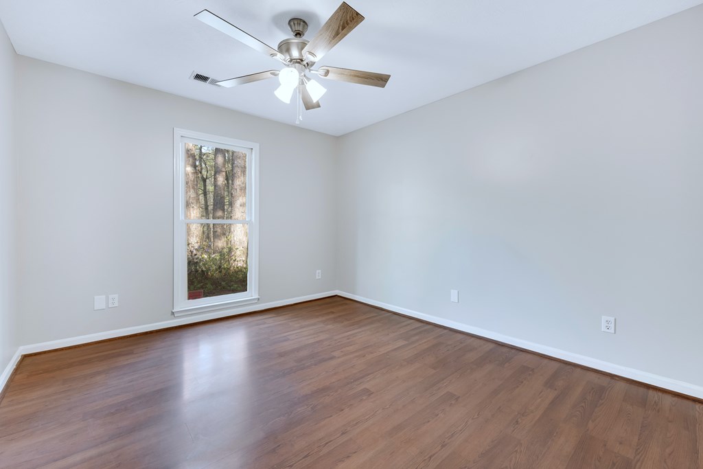 3330 Fortson Road Fortson, GA 31808 - Photo 34 of 46 an empty room with wooden floor and windows