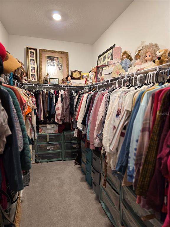 7875 Southwest 74th Street Ocala, FL 34474 - Photo 25 of 28 a view of walk in closet with clothes and shoes