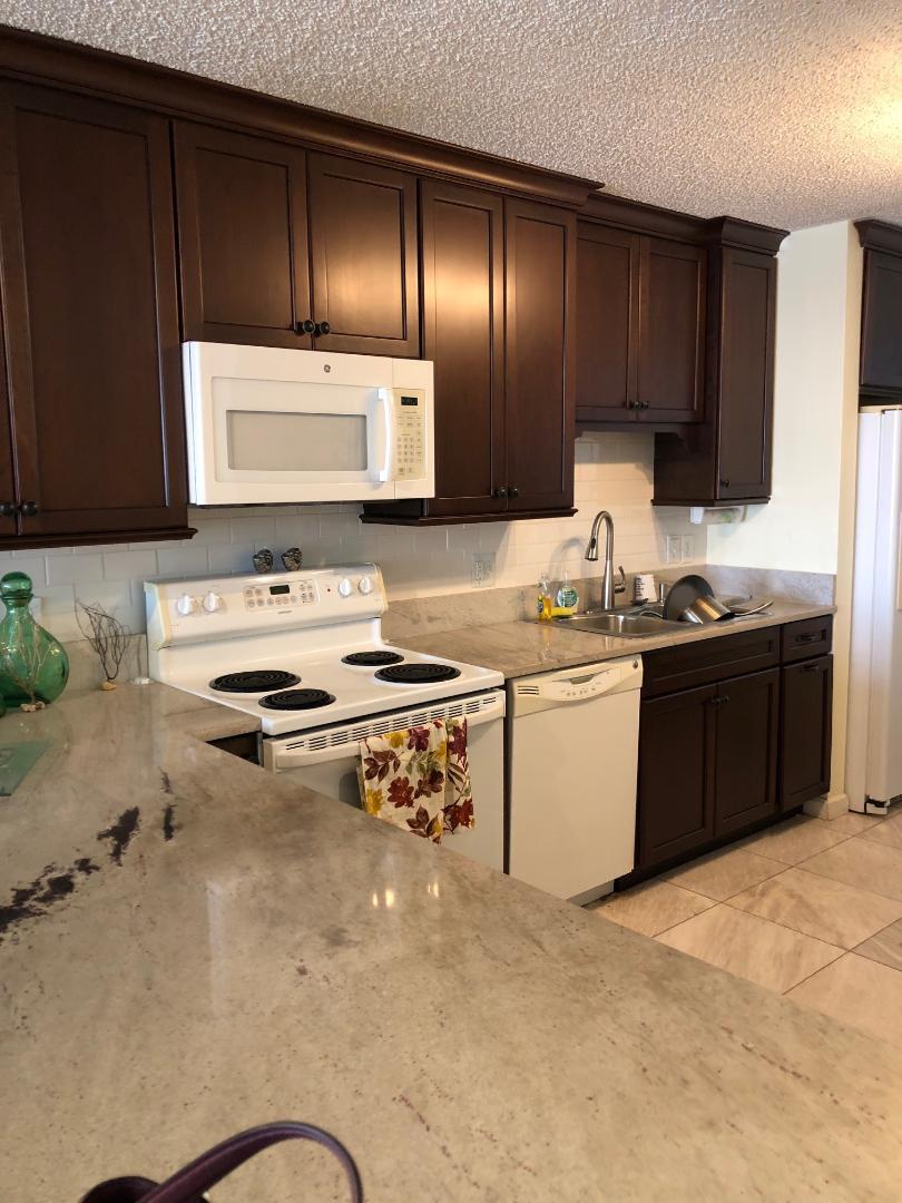 1901 South Roosevelt Boulevard, Unit 404S Key West, FL 33040 - Photo 12 of 39 a kitchen with stainless steel appliances granite countertop a sink stove and refrigerator