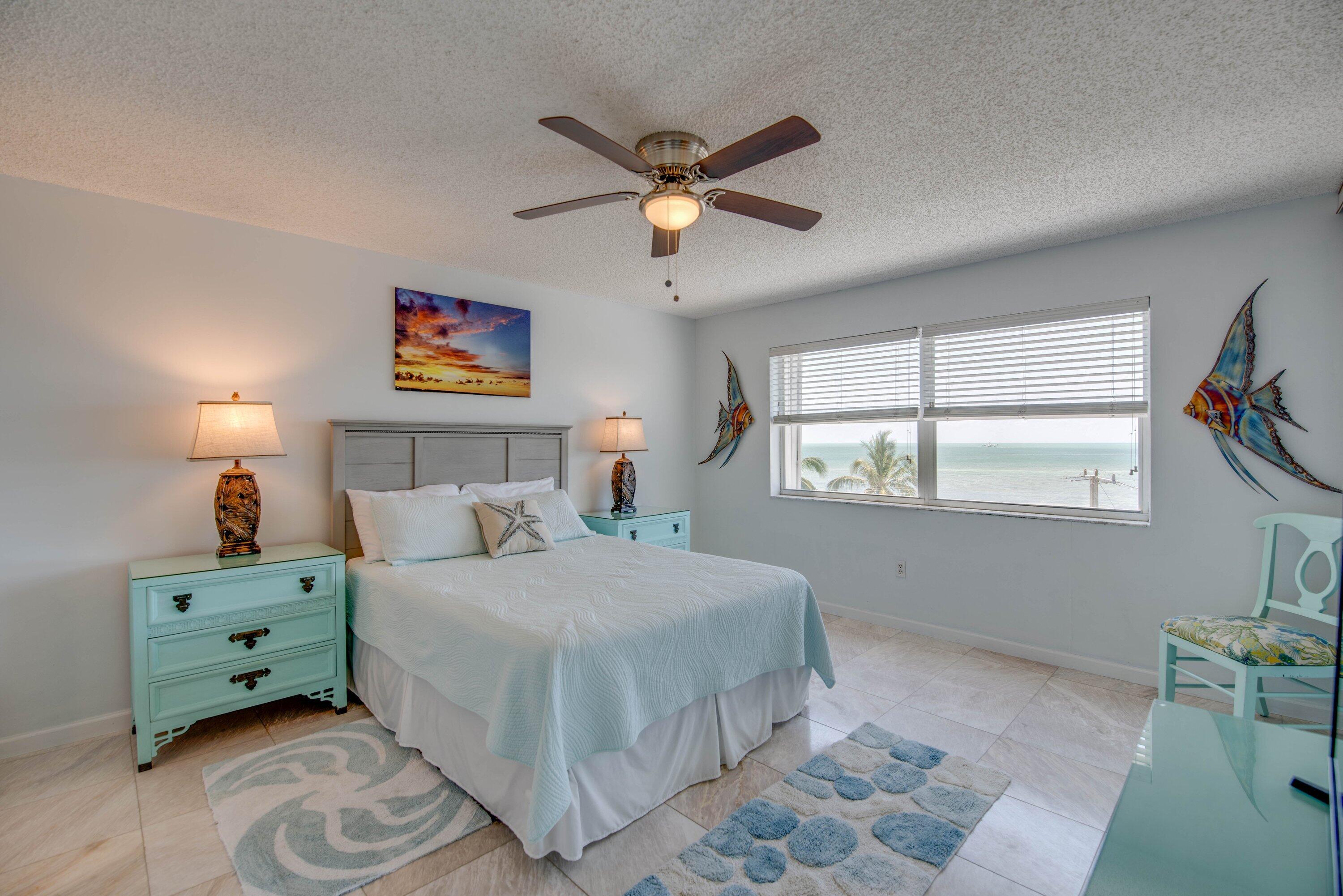 1901 South Roosevelt Boulevard, Unit 404S Key West, FL 33040 - Photo 13 of 39 a bedroom with a bed and a window