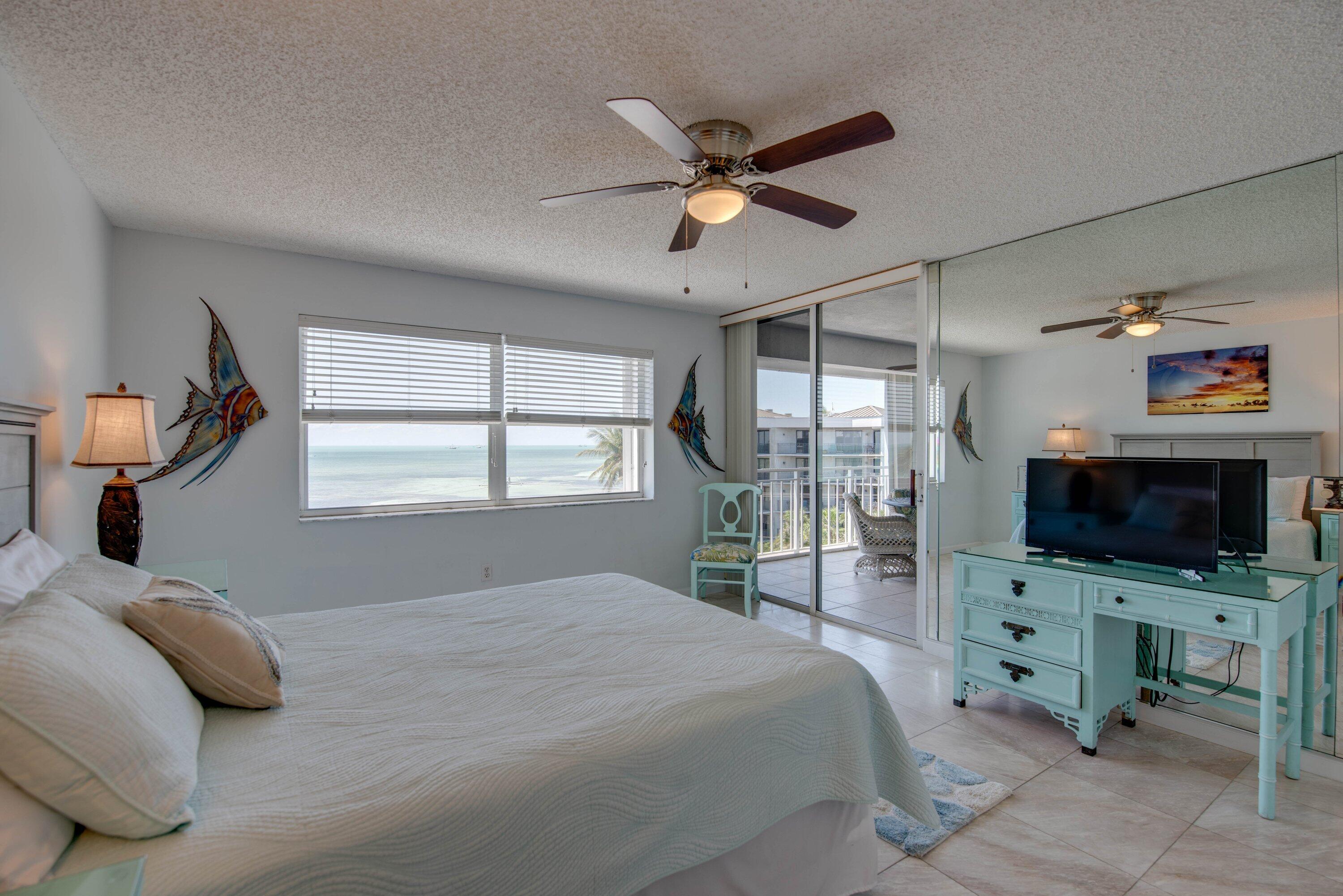 1901 South Roosevelt Boulevard, Unit 404S Key West, FL 33040 - Photo 14 of 39 a bedroom with a bed and a flat screen tv