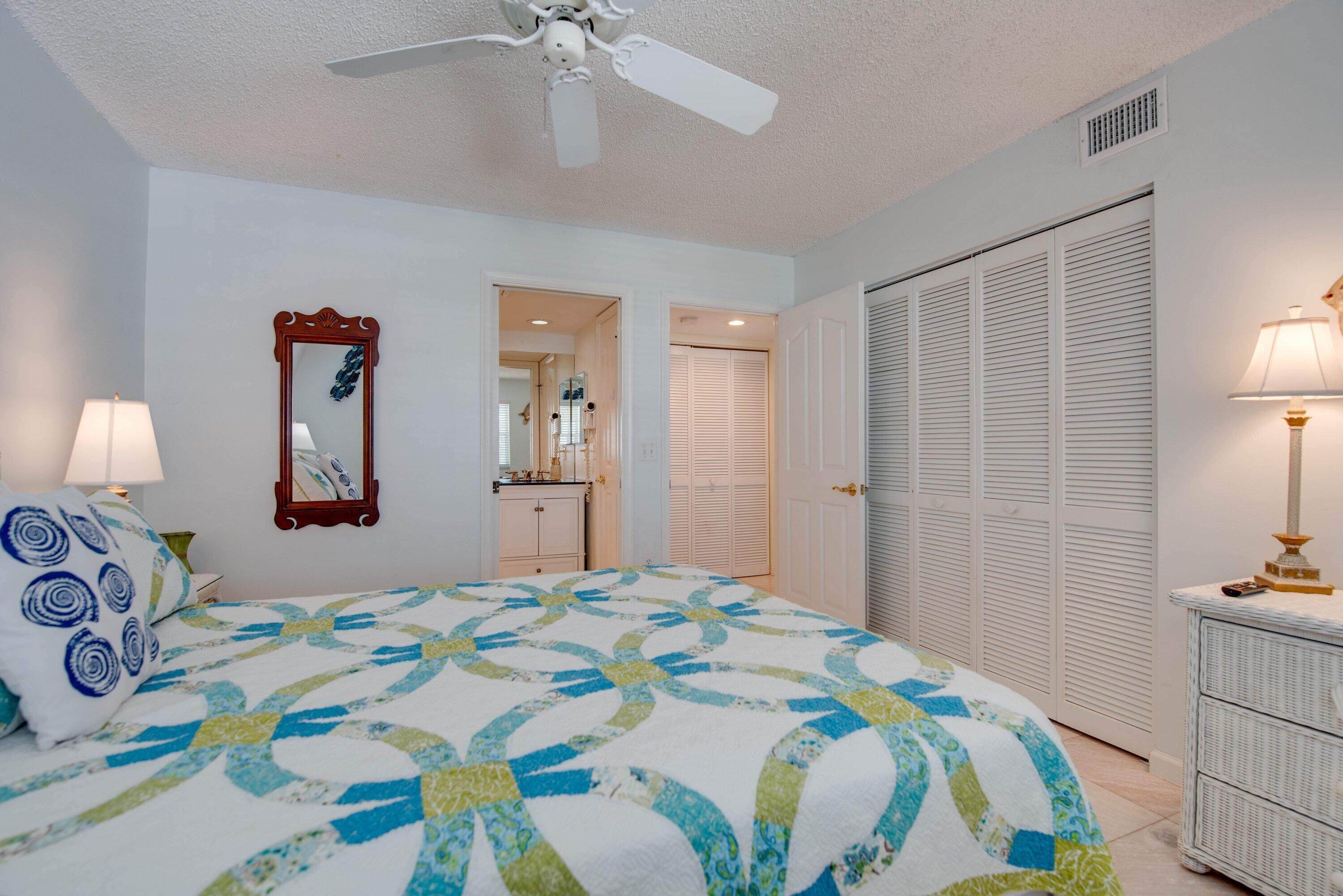 1901 South Roosevelt Boulevard, Unit 404S Key West, FL 33040 - Photo 16 of 39 a bedroom with a bed and a lamp on dresser