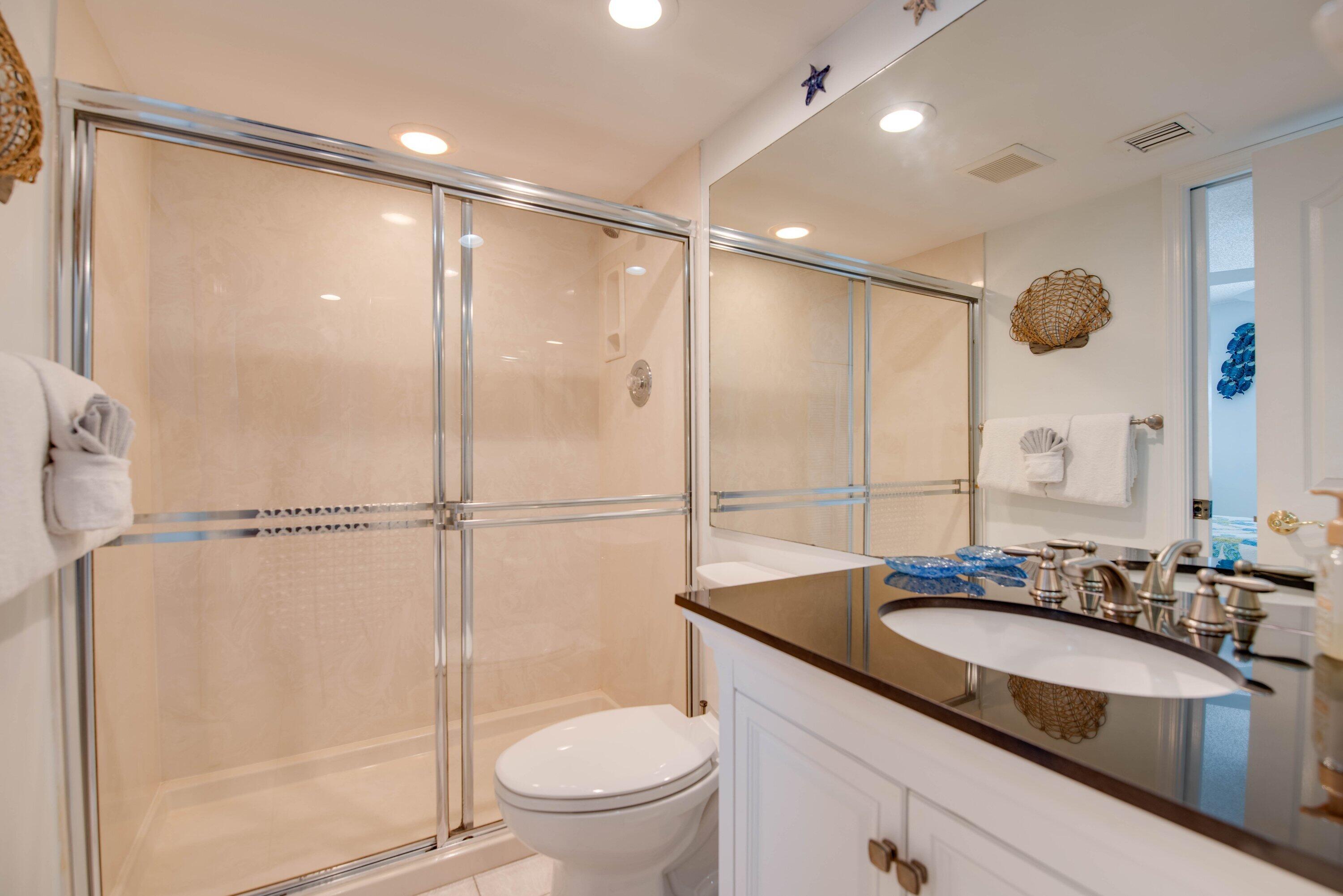 1901 South Roosevelt Boulevard, Unit 404S Key West, FL 33040 - Photo 17 of 39 a bathroom with a granite countertop sink toilet and shower