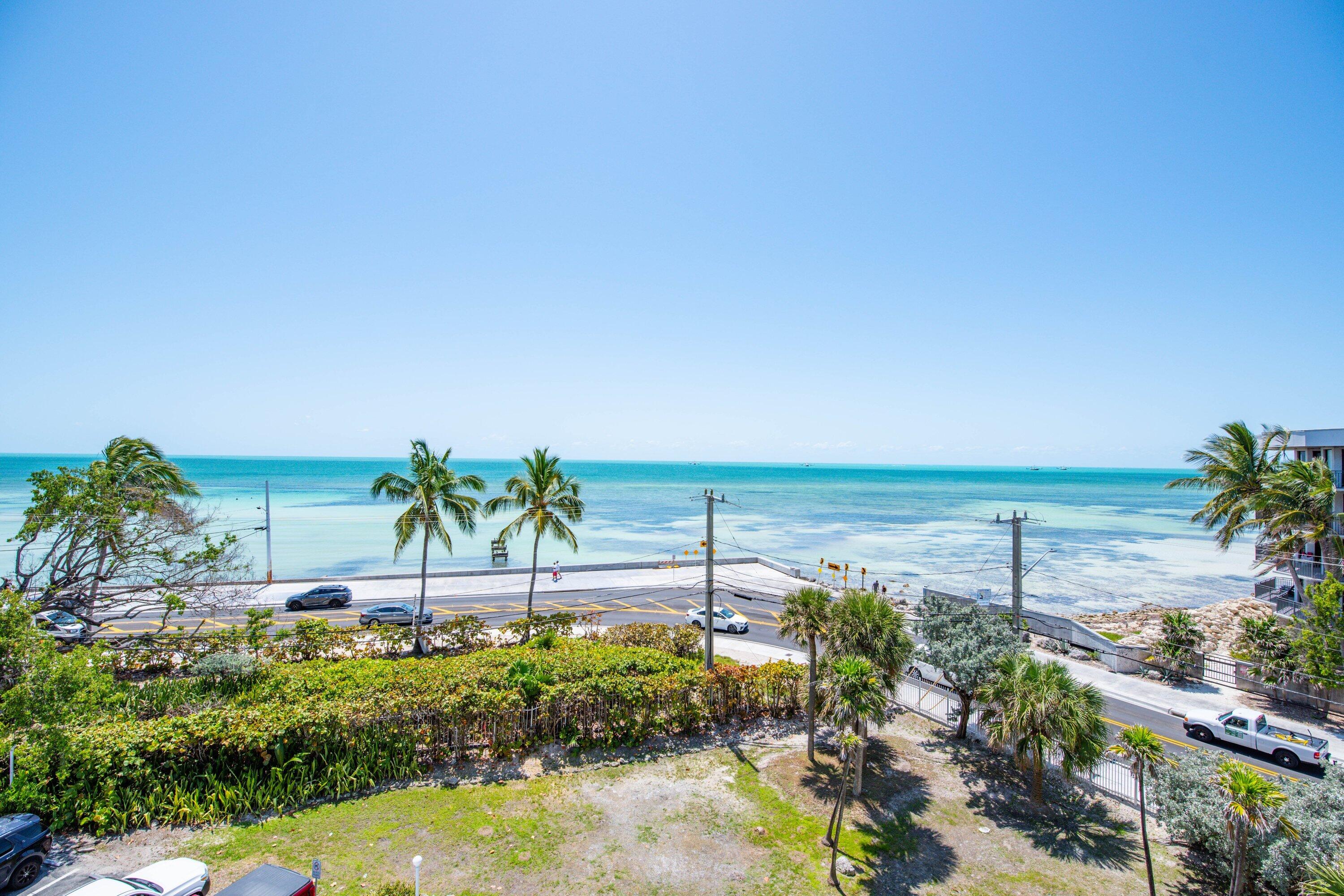 1901 South Roosevelt Boulevard, Unit 404S Key West, FL 33040 - Photo 2 of 39 a view of ocean with a palm tree