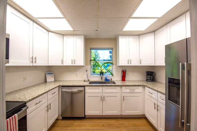 1901 South Roosevelt Boulevard, Unit 404S Key West, FL 33040 - Photo 32 of 39 a kitchen with a sink cabinets stainless steel appliances and a window