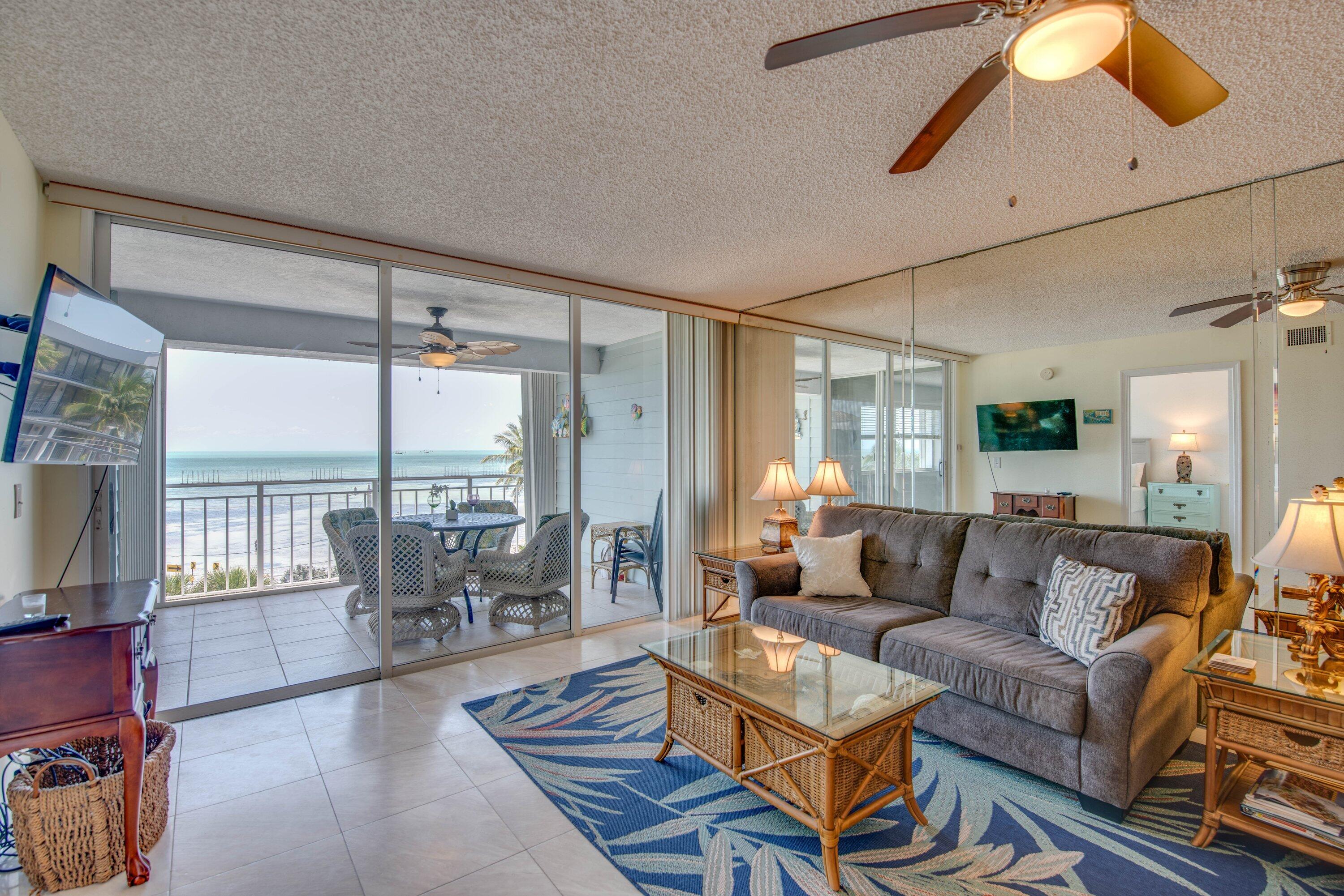 1901 South Roosevelt Boulevard, Unit 404S Key West, FL 33040 - Photo 5 of 39 a living room with furniture and a large window
