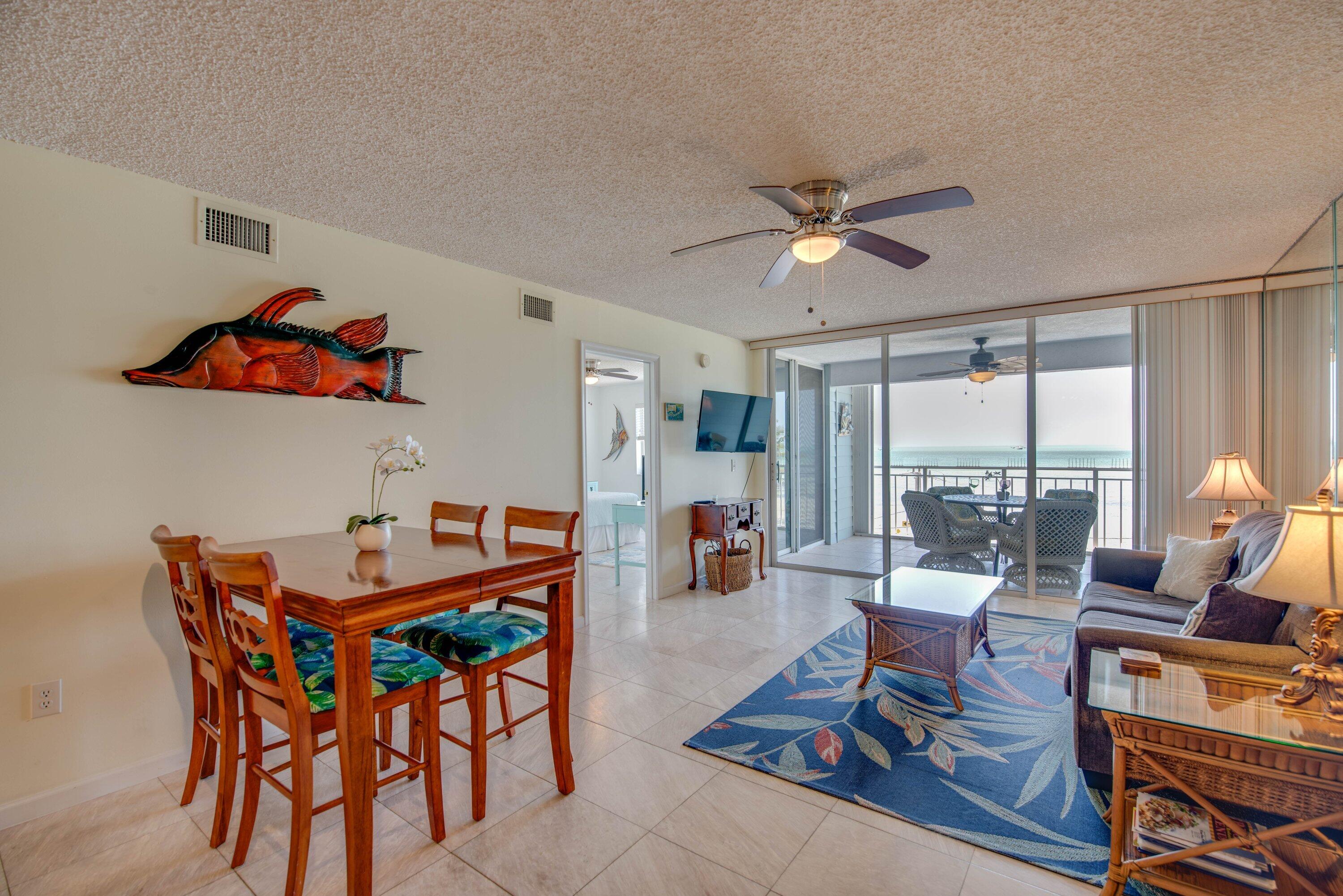 1901 South Roosevelt Boulevard, Unit 404S Key West, FL 33040 - Photo 7 of 39 a living room with furniture a large window and a table