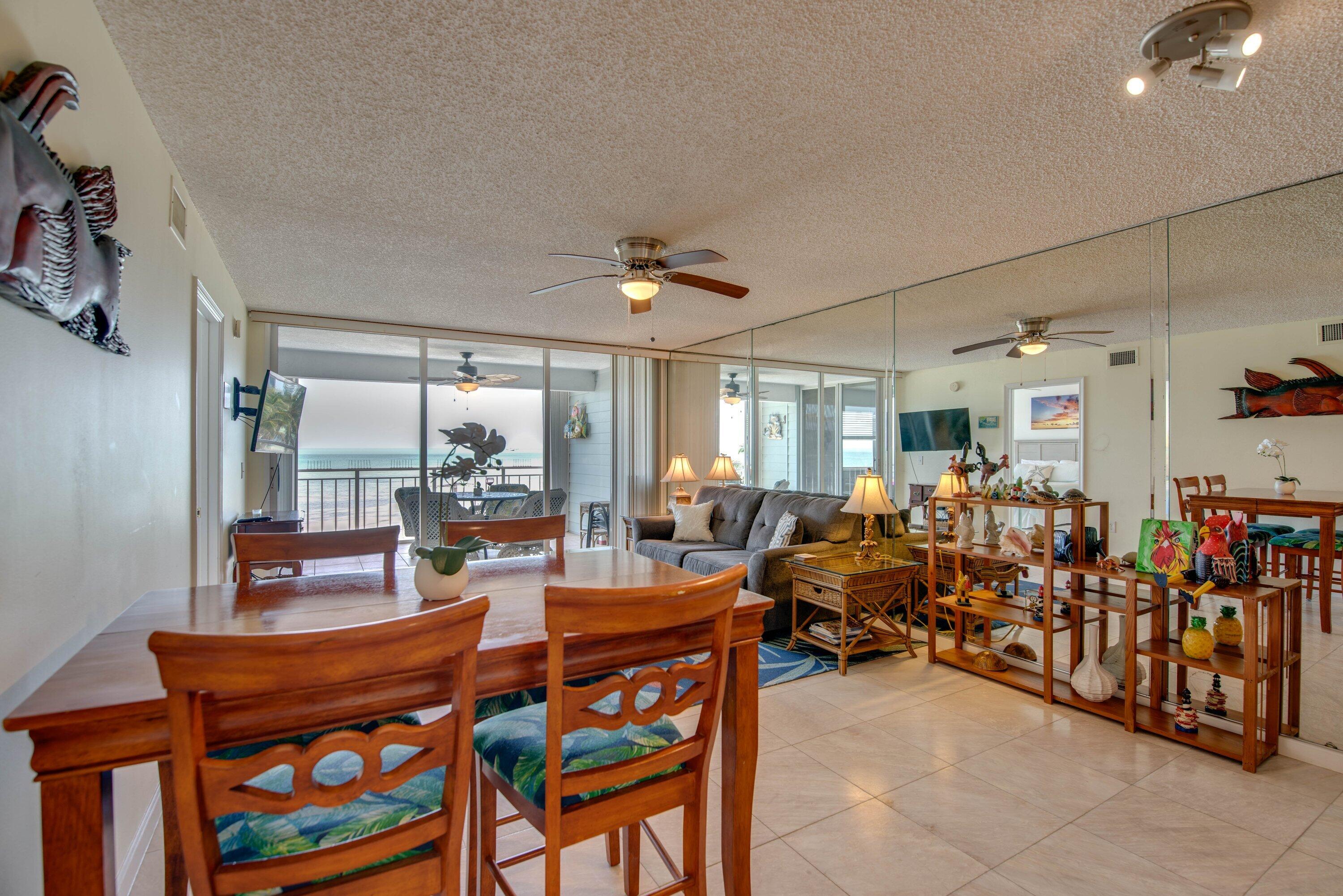 1901 South Roosevelt Boulevard, Unit 404S Key West, FL 33040 - Photo 8 of 39 a room with lots of wooden furniture and a chandelier