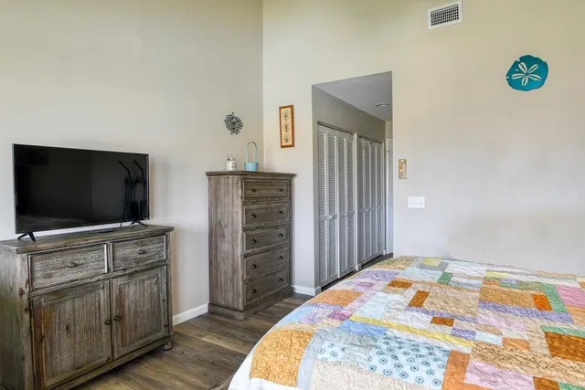 a bedroom with a bed and a flat screen tv