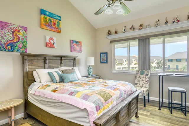 a bedroom with a bed and a large window