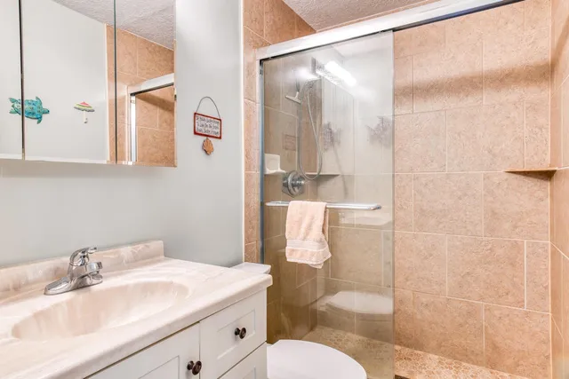 a bathroom with a sink toilet and shower