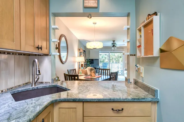 a kitchen with sink and a mirror