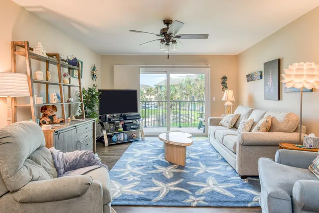 a living room with furniture a rug and a large window