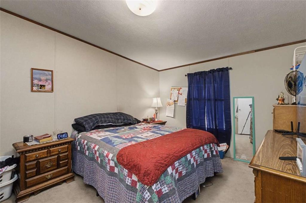 1343 Prior Station Road Cedartown, GA 30125 - Photo 18 of 39 a bedroom with a bed and a flat tv screen on a dresser