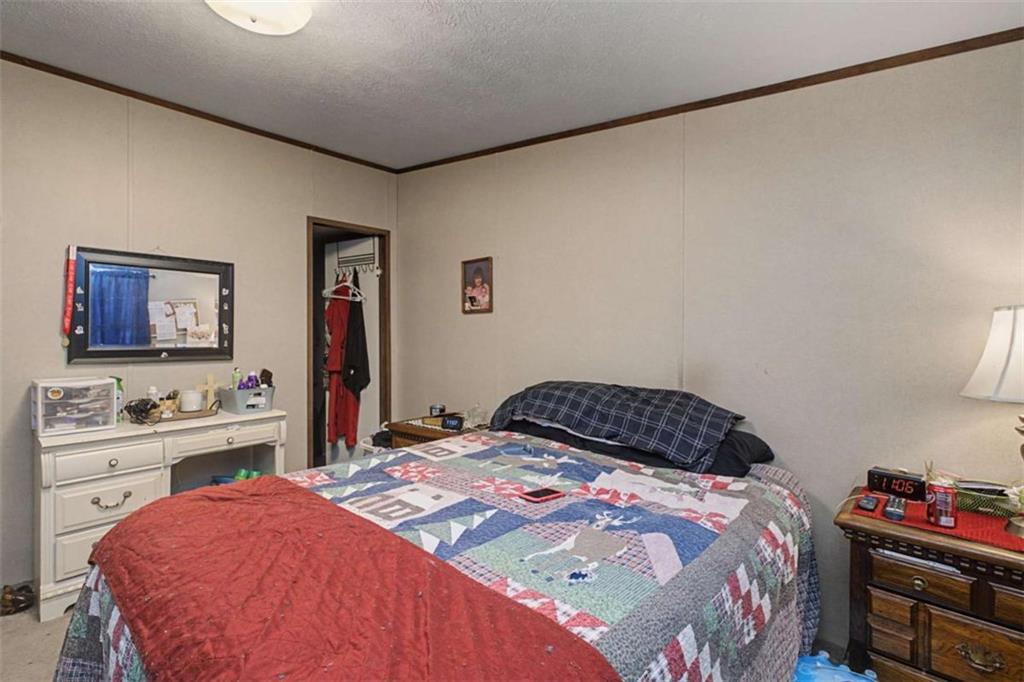 1343 Prior Station Road Cedartown, GA 30125 - Photo 19 of 39 a bedroom with a bed and a desk in it