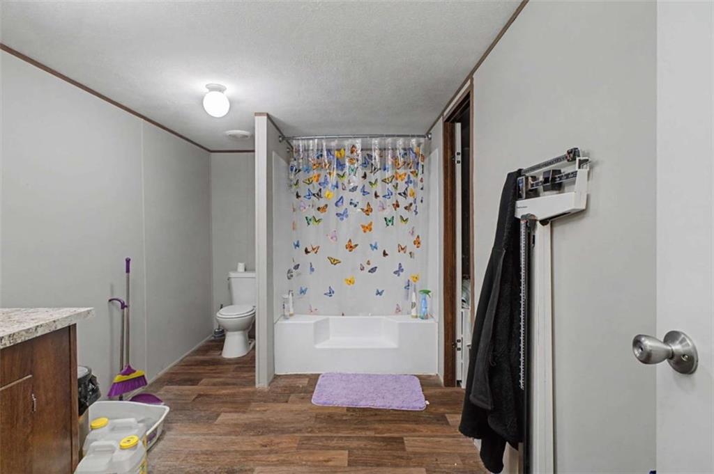 1343 Prior Station Road Cedartown, GA 30125 - Photo 23 of 39 a view of a hallway with wooden floor and a bathroom