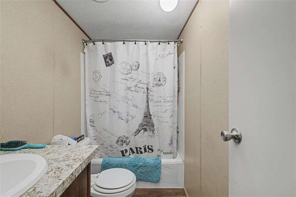 1343 Prior Station Road Cedartown, GA 30125 - Photo 26 of 39 a bathroom with a granite countertop sink toilet and shower