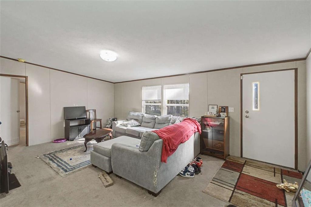 1343 Prior Station Road Cedartown, GA 30125 - Photo 5 of 39 a living room with furniture and a flat screen tv