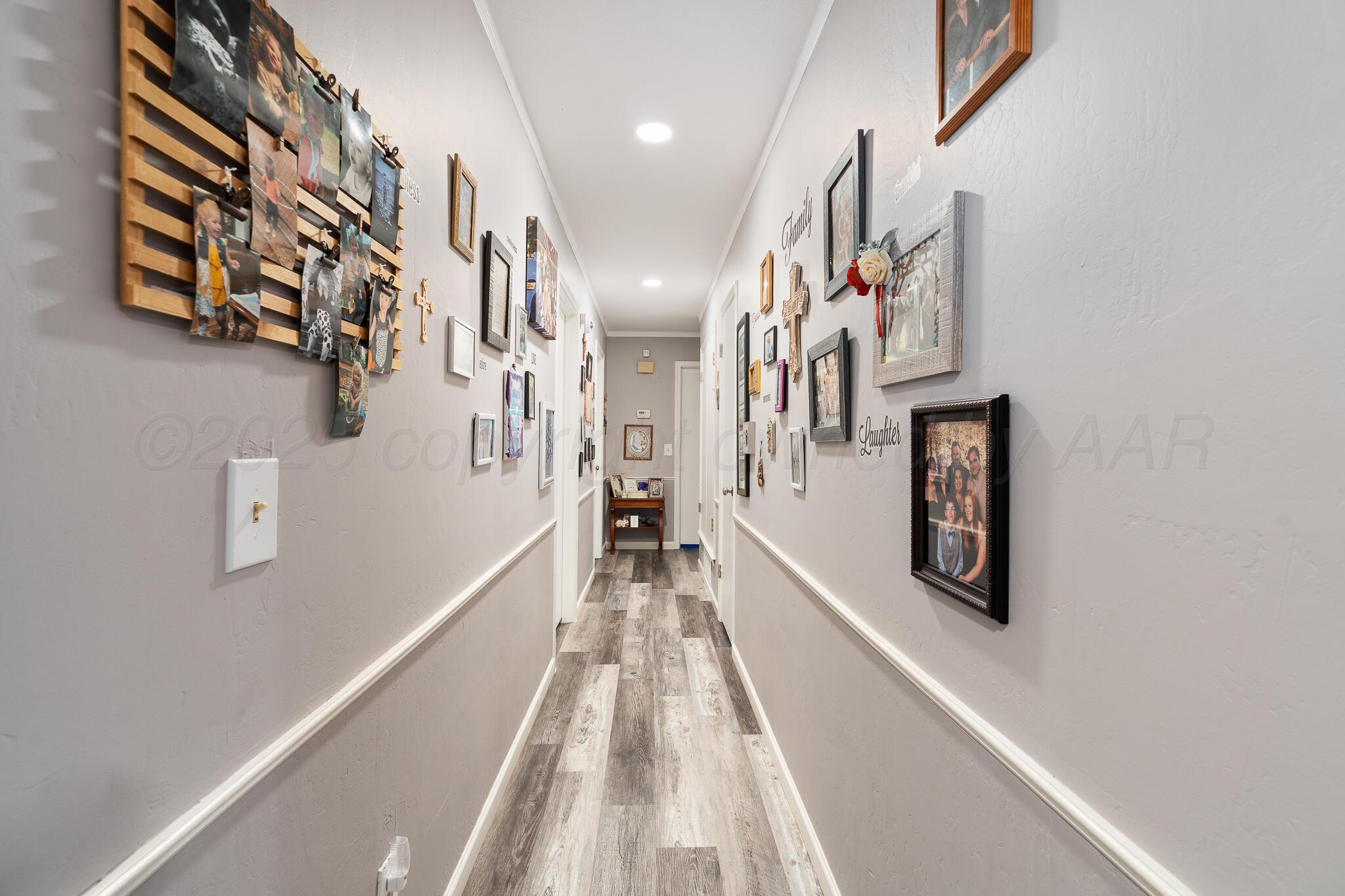 4307 Harmony Street Amarillo, TX 79109 - Photo 12 of 25 a view of a hallway with wooden floor and staircase