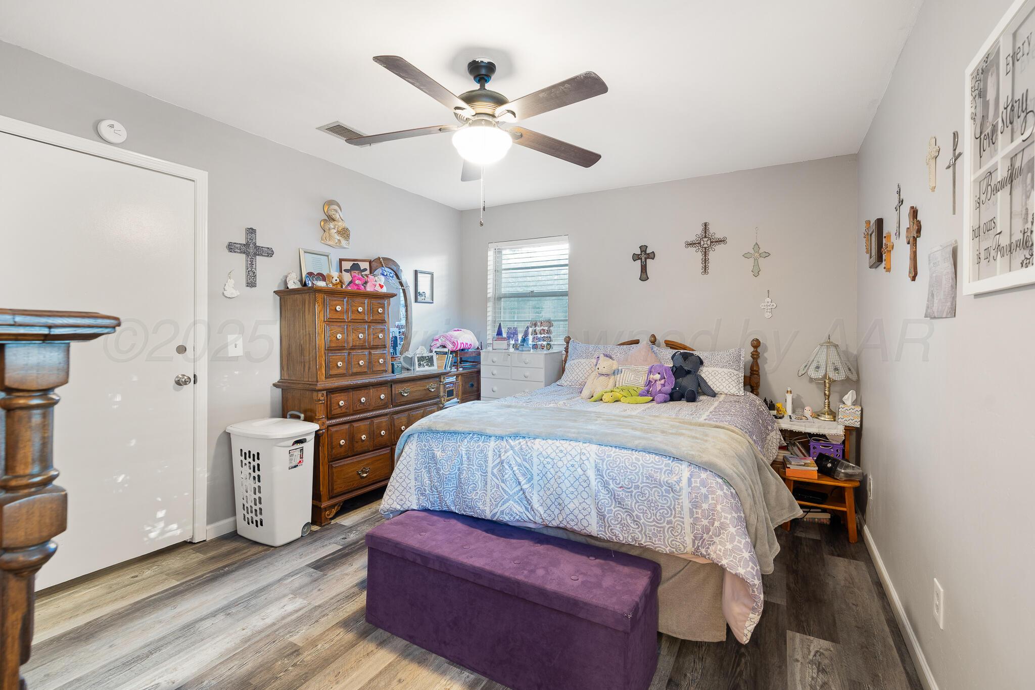 4307 Harmony Street Amarillo, TX 79109 - Photo 14 of 25 a bedroom with a bed and a ceiling fan