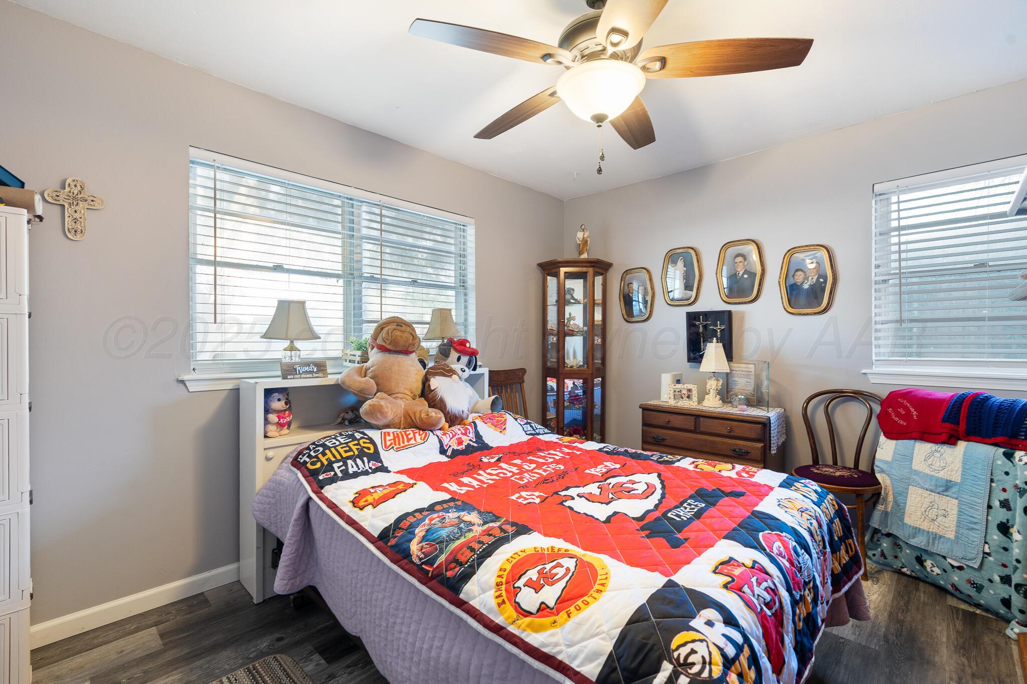 4307 Harmony Street Amarillo, TX 79109 - Photo 15 of 25 a bedroom with a bed and a chandelier