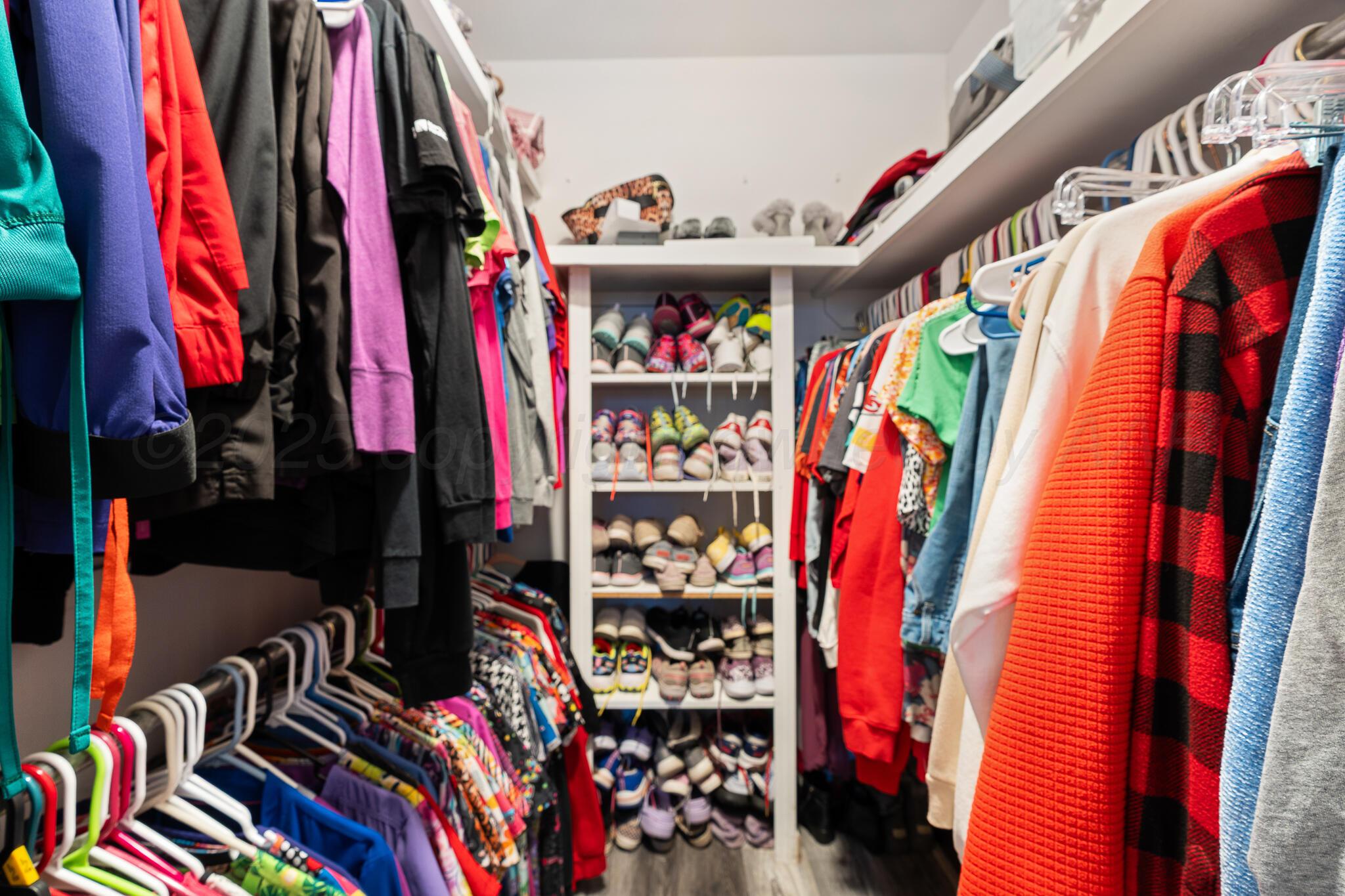 4307 Harmony Street Amarillo, TX 79109 - Photo 19 of 25 a view of walk in closet with clothes