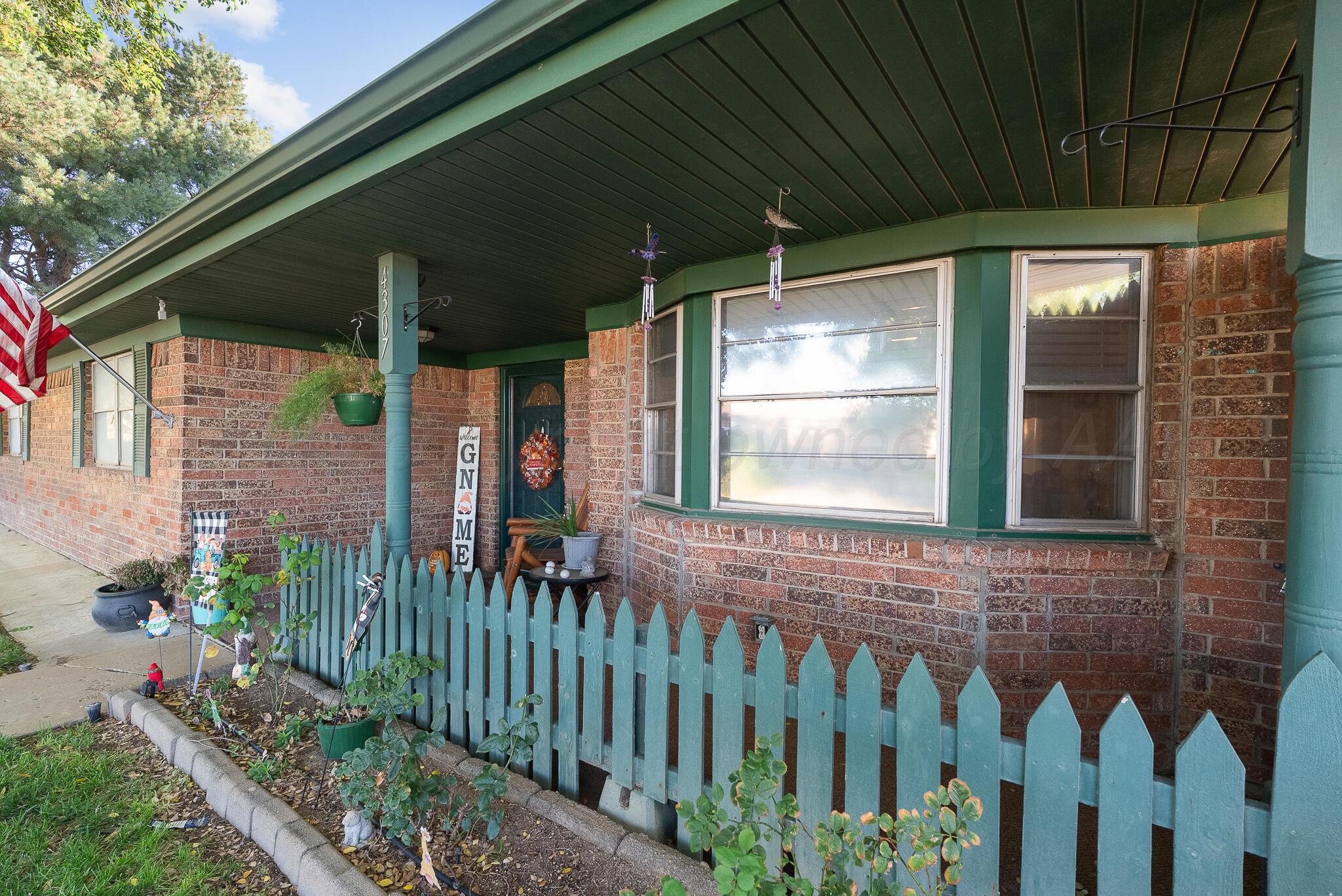 4307 Harmony Street Amarillo, TX 79109 - Photo 2 of 25 a view of a house with wooden fence