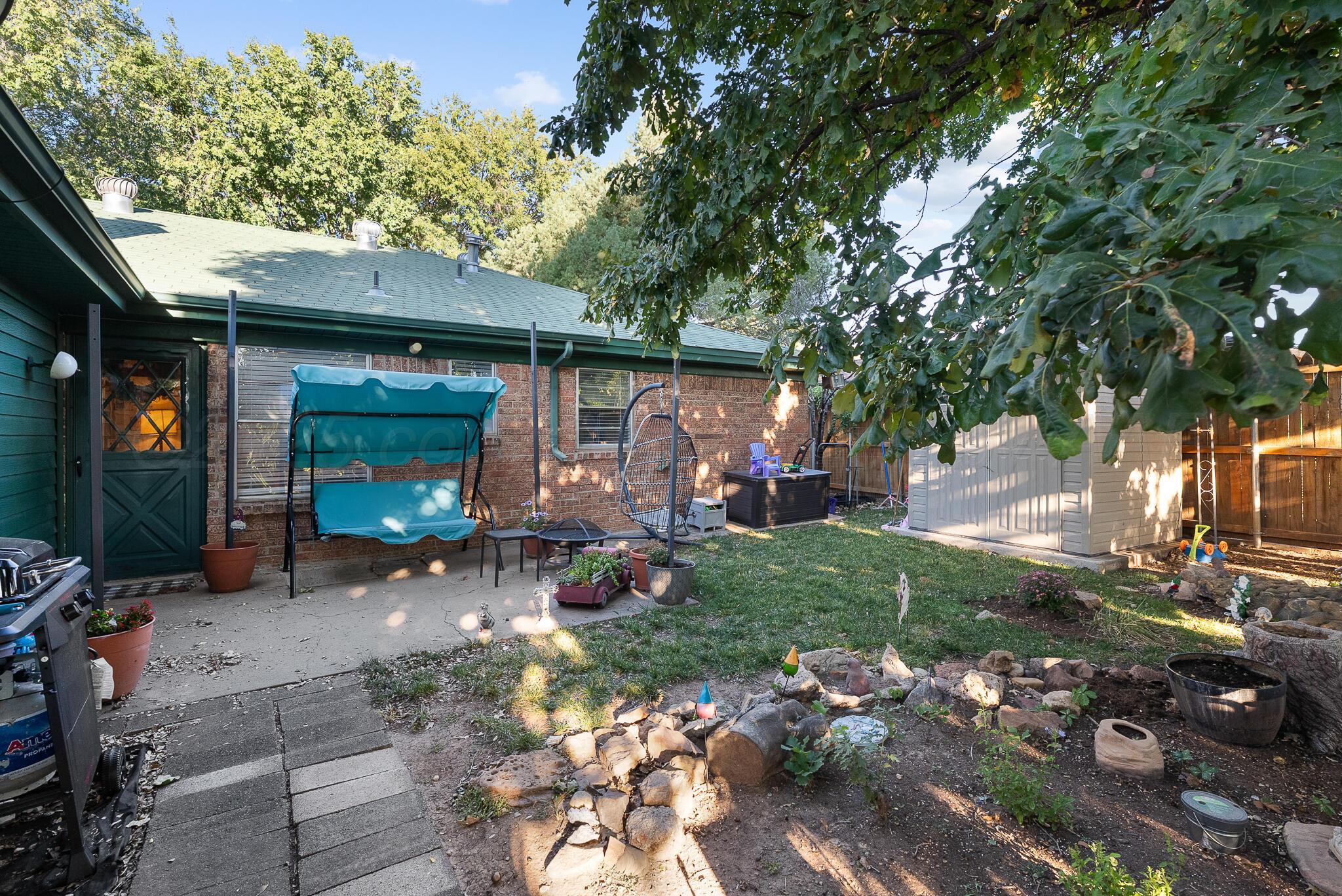 4307 Harmony Street Amarillo, TX 79109 - Photo 22 of 25 a view of a chair and table in backyard of the house