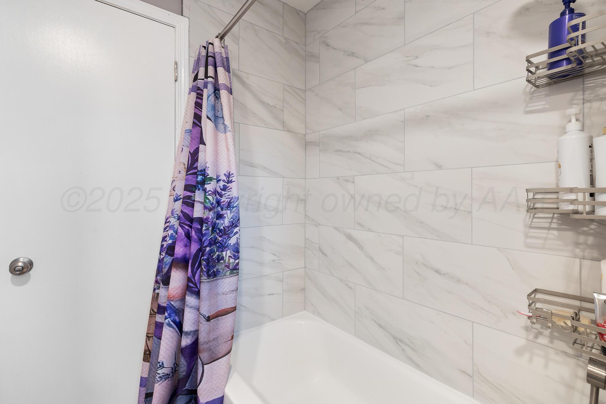 4307 Harmony Street Amarillo, TX 79109 - Photo 25 of 25 a bathroom with a bathtub and shower