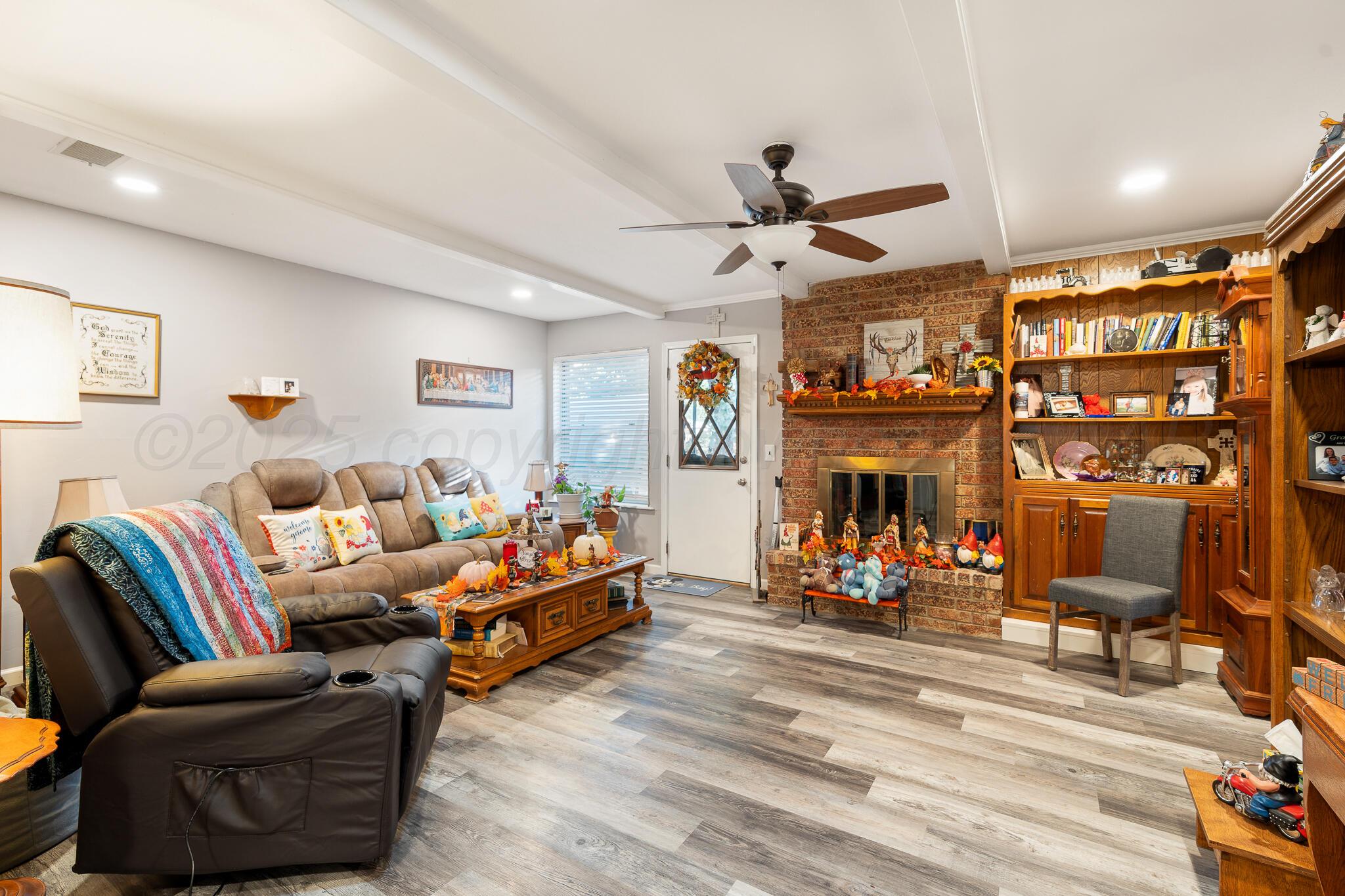 4307 Harmony Street Amarillo, TX 79109 - Photo 5 of 25 a living room with furniture a fireplace and white walls
