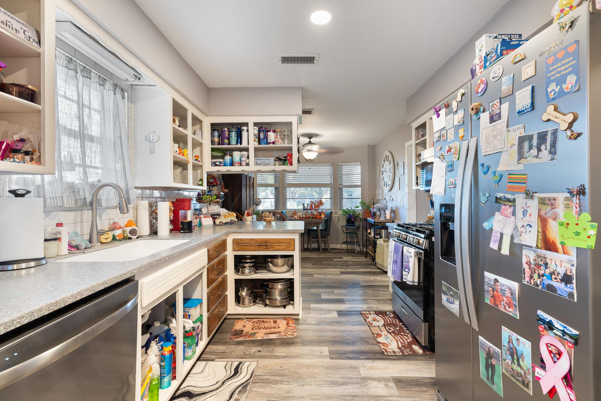 4307 Harmony Street Amarillo, TX 79109 - Photo 7 of 25 a view of a kitchen with stainless steel appliances and cabinets