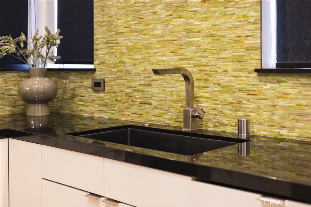 4557 Haskell Avenue, Unit 301 Encino, CA 91436 - Photo 11 of 40 a bathroom with a granite countertop sink a toilet and mirror