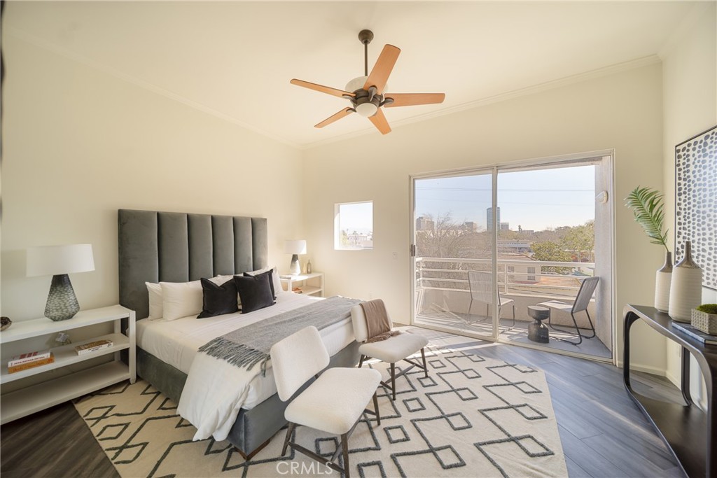 4557 Haskell Avenue, Unit 301 Encino, CA 91436 - Photo 16 of 40 a bedroom with a bed a couch and a large window with the outer view