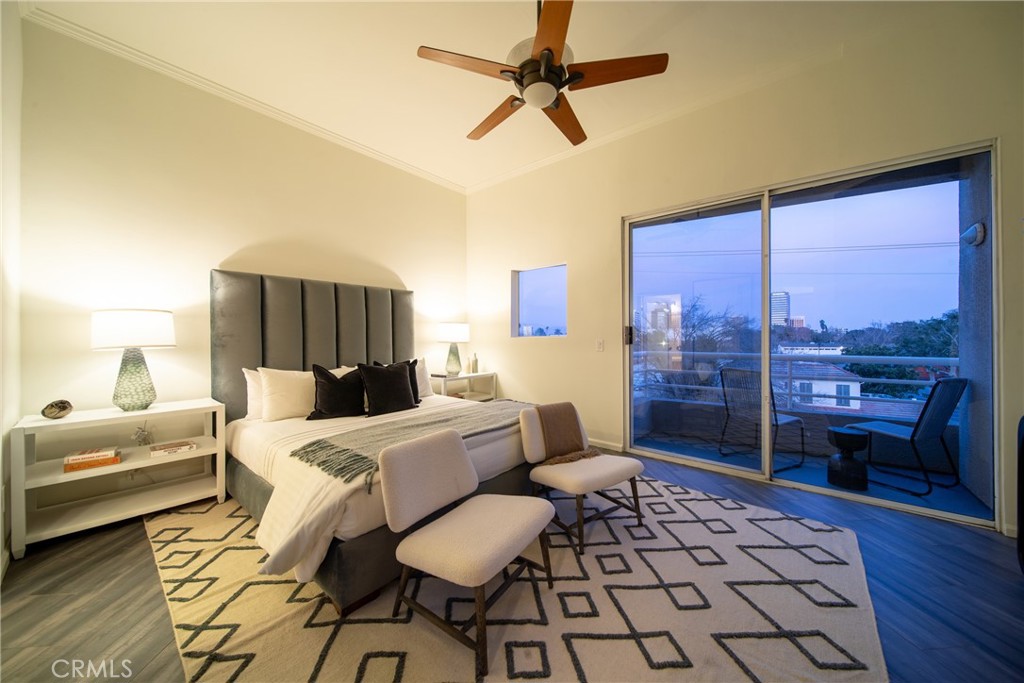 4557 Haskell Avenue, Unit 301 Encino, CA 91436 - Photo 17 of 40 a bedroom with a bed and wooden floor