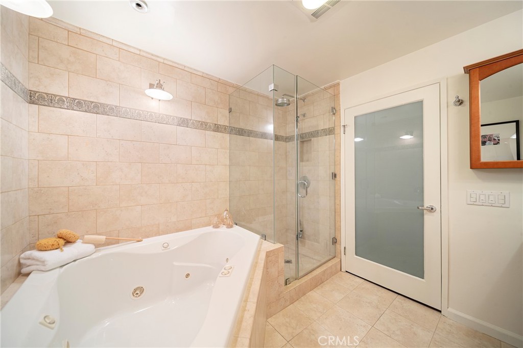 4557 Haskell Avenue, Unit 301 Encino, CA 91436 - Photo 20 of 40 a bathroom with a bathtub and a shower