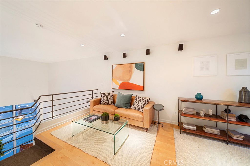 4557 Haskell Avenue, Unit 301 Encino, CA 91436 - Photo 31 of 40 a living room with furniture and white walls