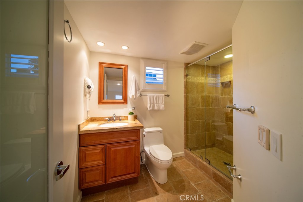 4557 Haskell Avenue, Unit 301 Encino, CA 91436 - Photo 33 of 40 a bathroom with a granite countertop toilet a sink and shower