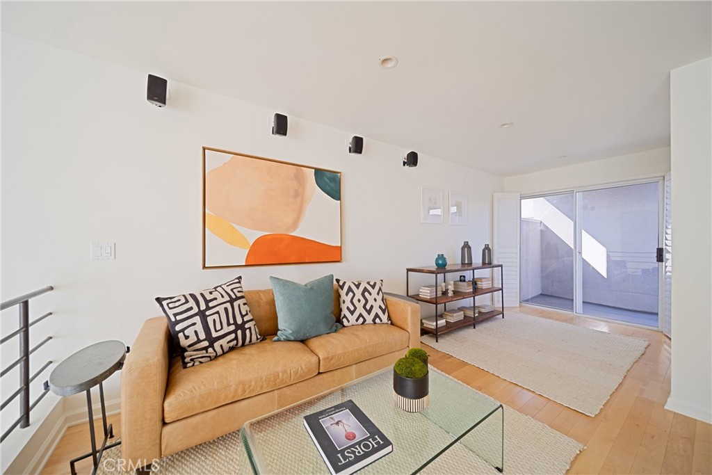 4557 Haskell Avenue, Unit 301 Encino, CA 91436 - Photo 34 of 40 a living room with furniture and a wooden floor
