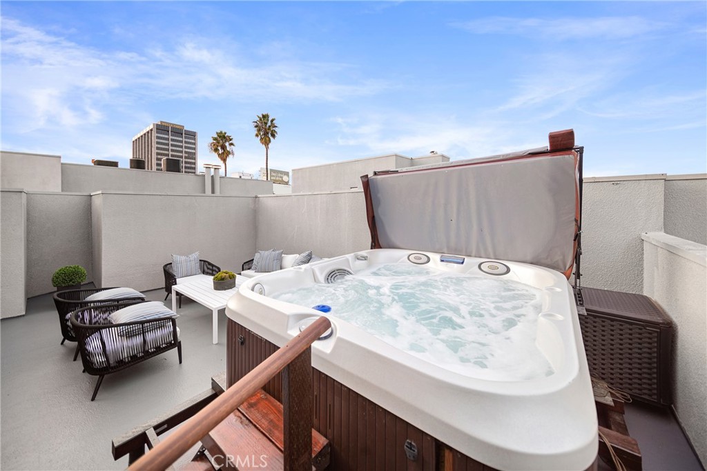 4557 Haskell Avenue, Unit 301 Encino, CA 91436 - Photo 38 of 40 a bed sitting in a bedroom next to a window with pc on the table