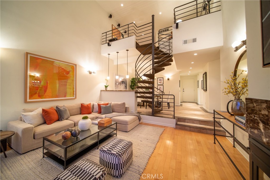 4557 Haskell Avenue, Unit 301 Encino, CA 91436 - Photo 4 of 40 a living room with furniture a rug and a chandelier